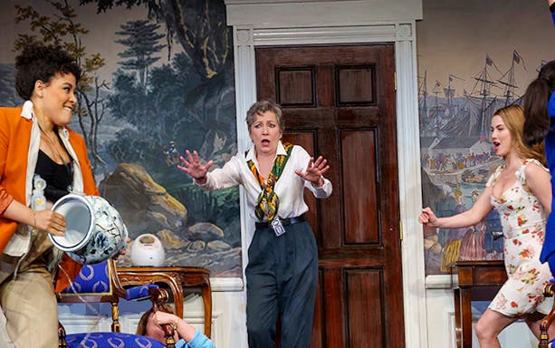 Women in a comedic scene from "POTUS" play, with one holding a vase and another reacting.