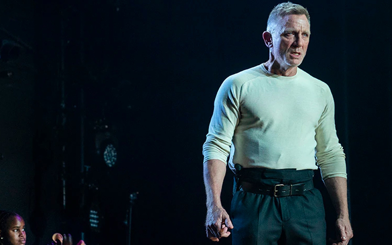 Actor performing Macbeth on stage in a dramatic scene.