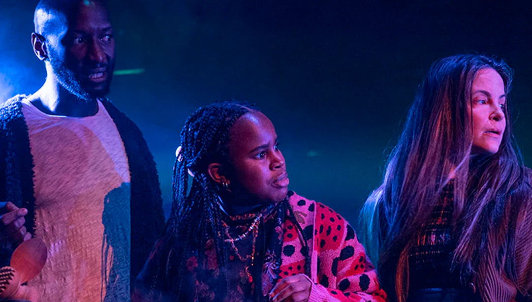 Actors performing a scene from Macbeth on stage.