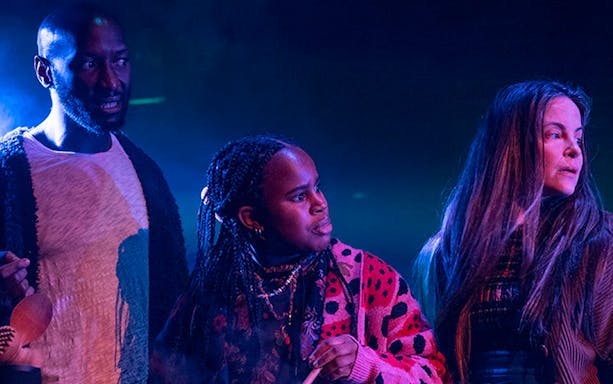 Actors performing a scene from Macbeth on stage.