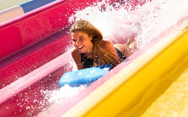 Person enjoying a water slide at Mirabeach.