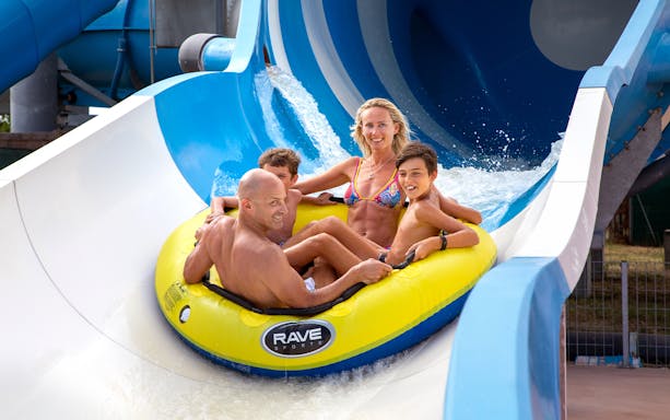 Family enjoying a water slide ride at Mirabeach.