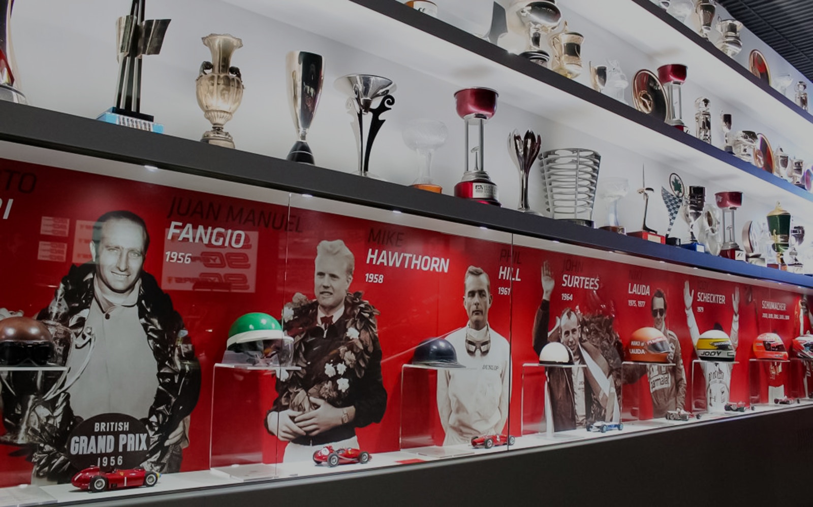 Ferrari Museum Maranello display of racing trophies and driver portraits.
