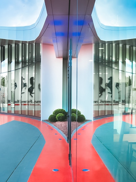 Ferrari Museum Maranello entrance with red and blue pathway.