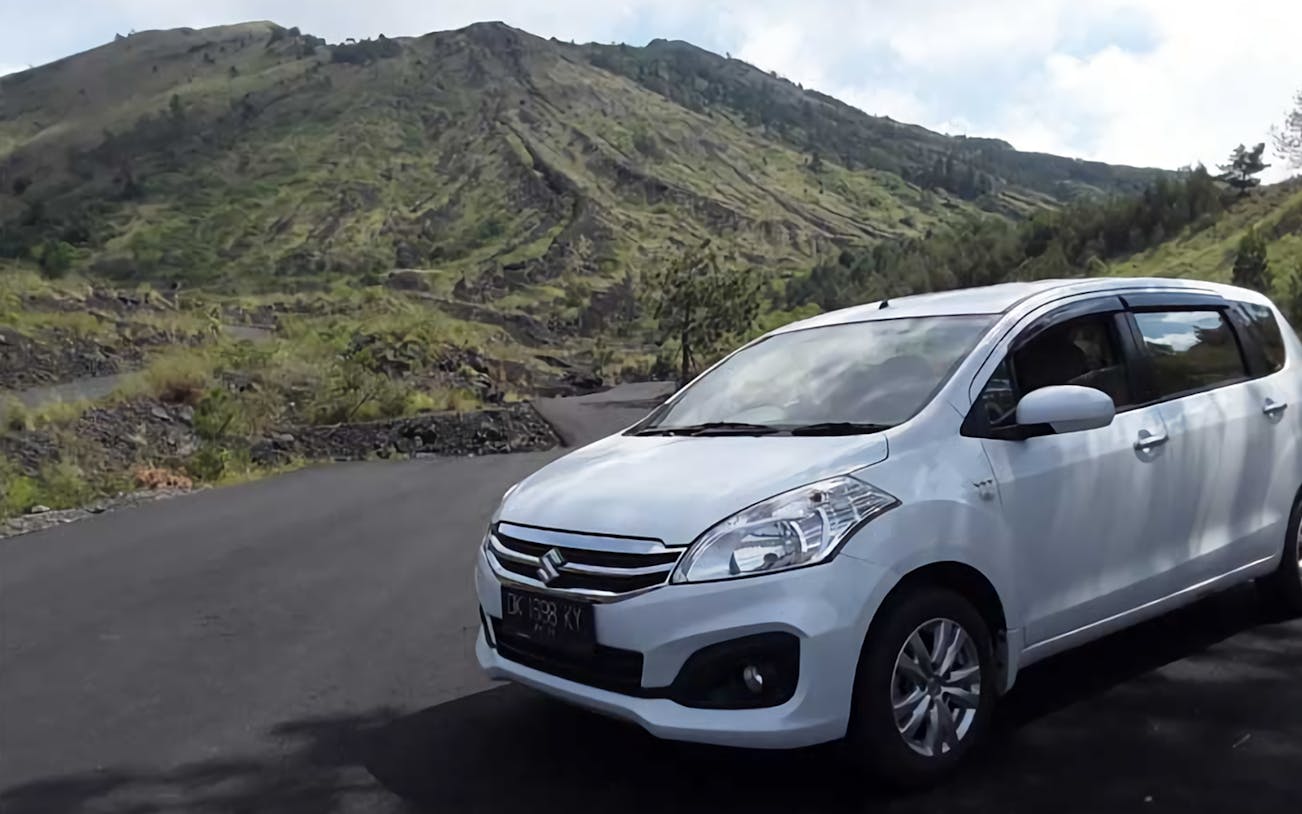 Private car with driver on a scenic road in Bali, Indonesia.