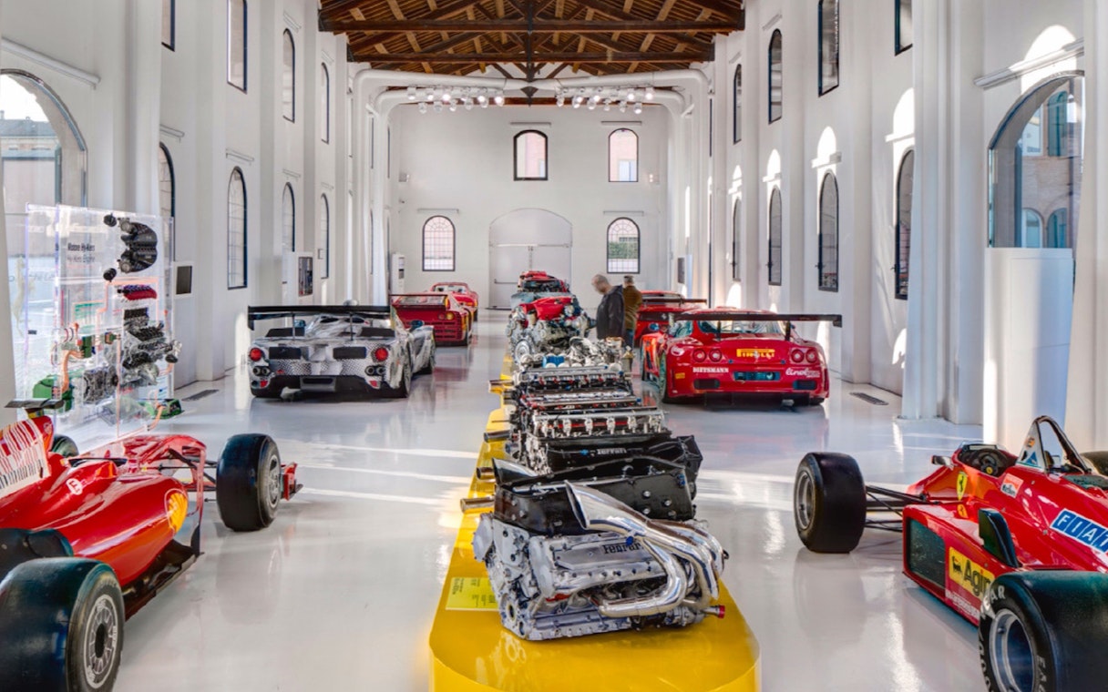 Ferrari engines and race cars displayed at Museo Enzo Ferrari Modena.