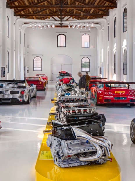 Ferrari engines and race cars displayed at Museo Enzo Ferrari Modena.