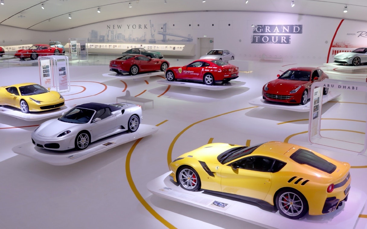 Ferrari cars on display at Museo Enzo Ferrari Modena exhibition hall.