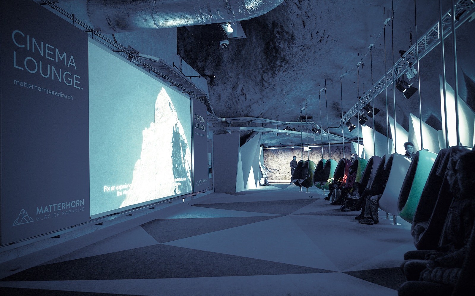 Visitors enjoying a film at the Cinema Lounge in Zermatt's Matterhorn Glacier Paradise.