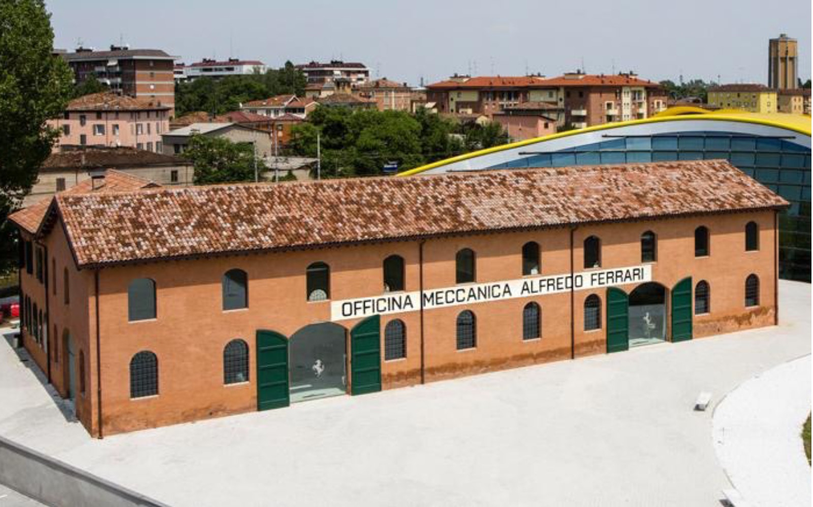 Maranello Ferrari Museum building exterior with "Officina Meccanica Alfredo Ferrari" sign.
