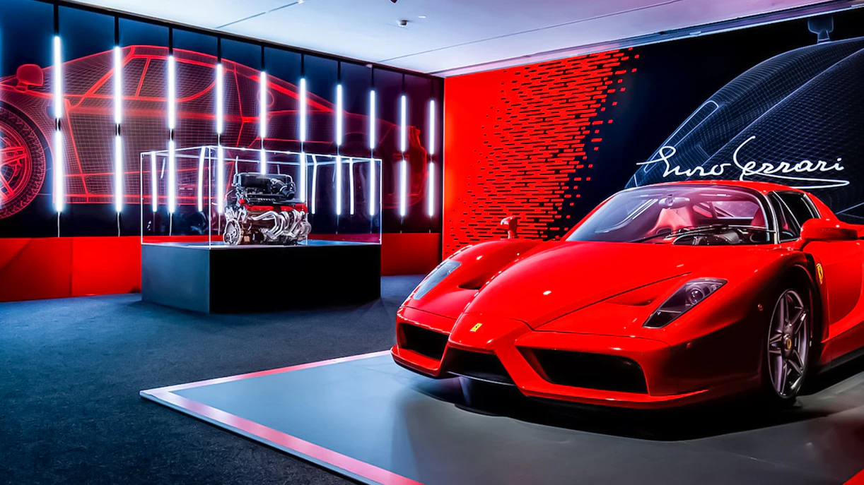 Ferrari Enzo display at Maranello Ferrari Museum with engine exhibit.