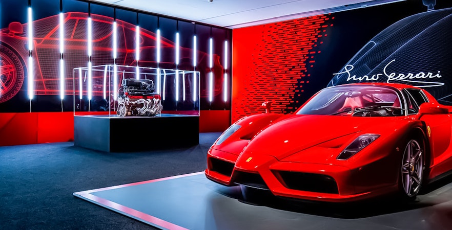 Ferrari Enzo display at Maranello Ferrari Museum with engine exhibit.