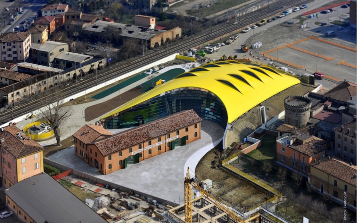 Aerial view of Modena Enzo Ferrari Museum with its distinctive yellow roof in Modena, Italy.