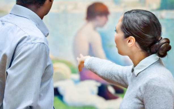 Visitors discussing a painting during the Official National Gallery Highlights Tour.