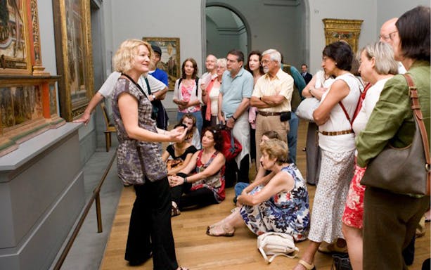 Group tour at the National Gallery with guide explaining paintings.