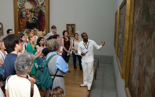 Tour guide explaining artwork to visitors at the National Gallery.