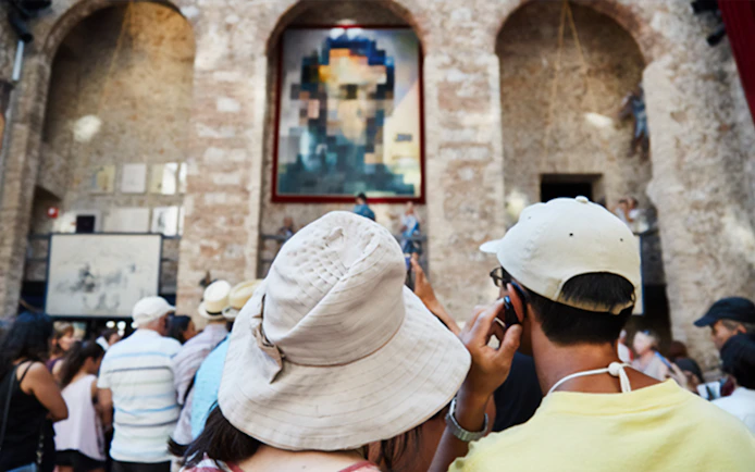Visitors at Dalí Theatre-Museum in Figueres viewing artwork.