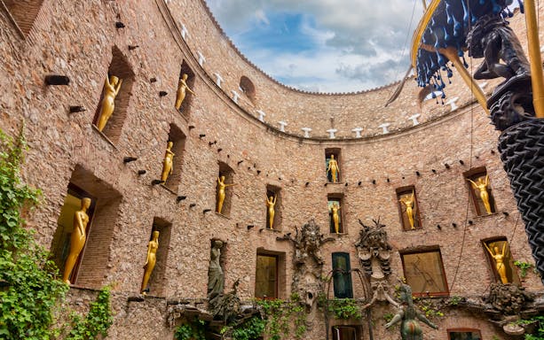 Dali Theatre-Museum courtyard with golden statues, Figueres, Spain.
