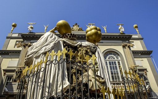 Sculpture at Dalí Theatre-Museum in Figueres, featuring surreal figures and golden elements.
