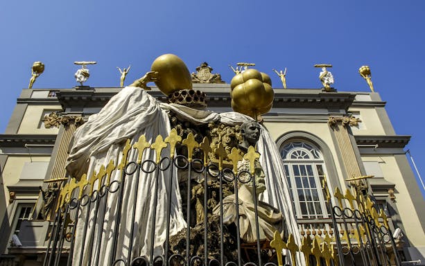 Sculpture at Dalí Theatre-Museum in Figueres, featuring surreal figures and golden elements.