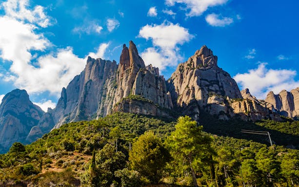 Montserrat mountain peaks under a blue sky in Catalonia, Spain.