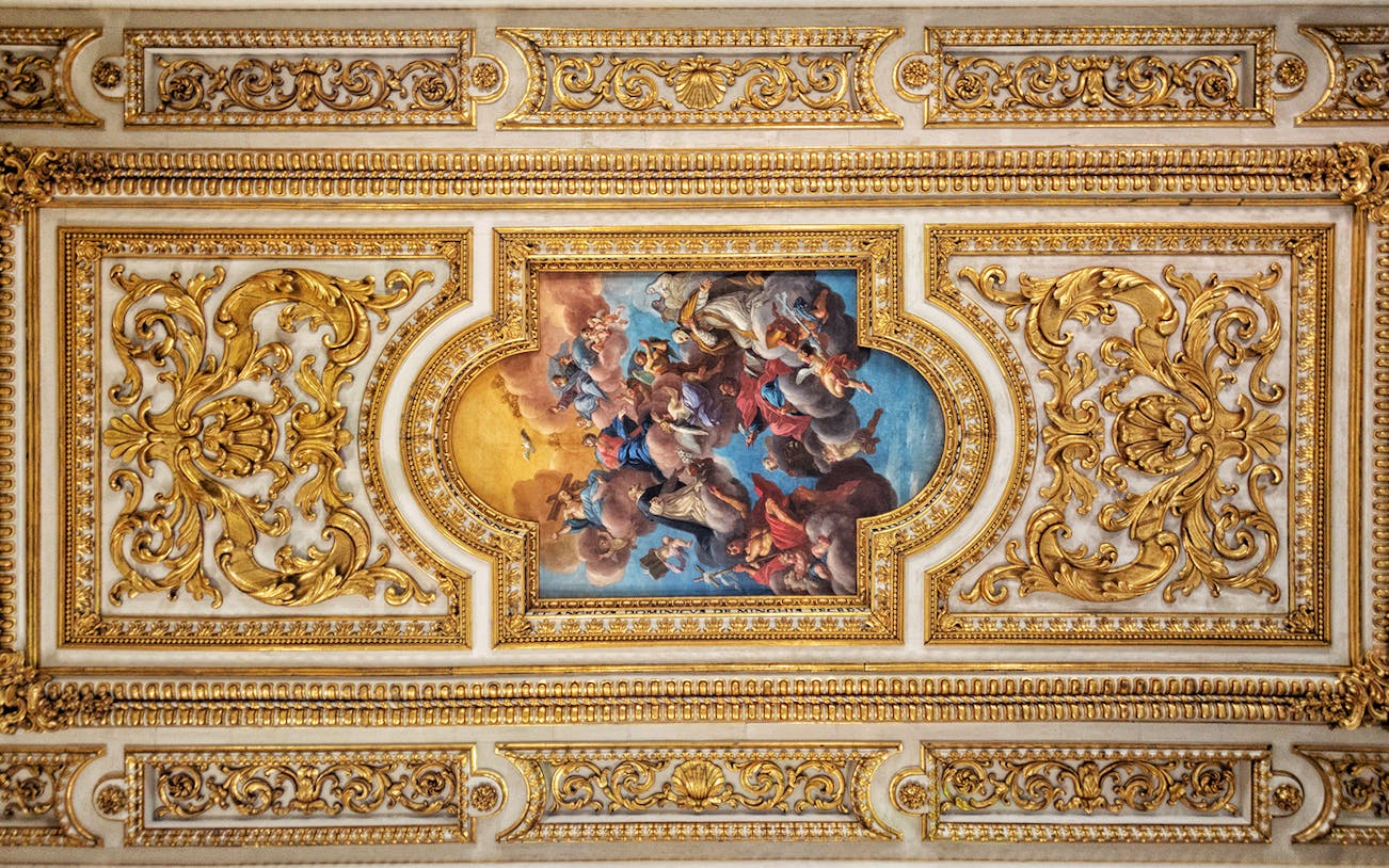Ornate ceiling fresco with gold detailing at San Marco Museum, Florence.
