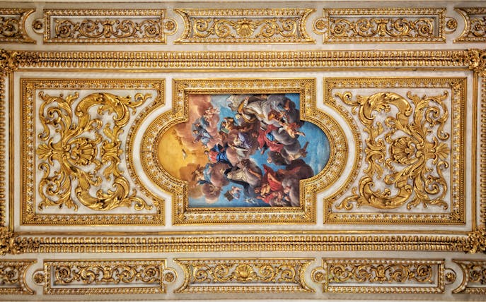 Ornate ceiling fresco with gold detailing at San Marco Museum, Florence.