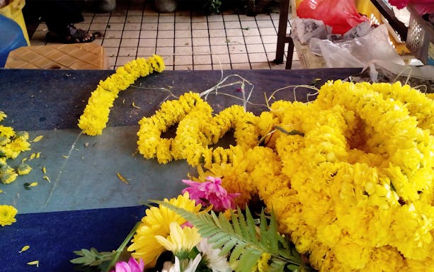 Yellow flower garlands on a market table in Georgetown, Penang Heritage Tour.