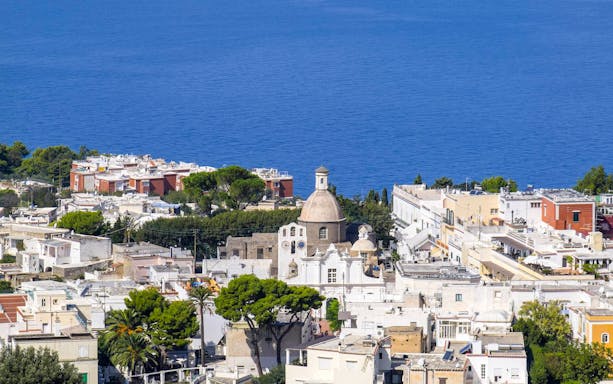 Capri Island townscape with church dome and sea view, part of guided tour with Sorrento transfers.