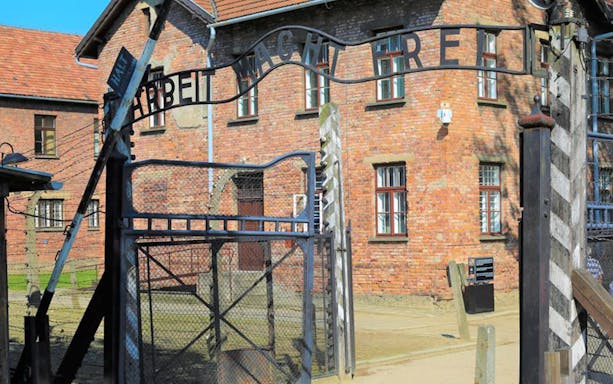 Auschwitz-Birkenau entrance gate with "Arbeit Macht Frei" sign, Poland.