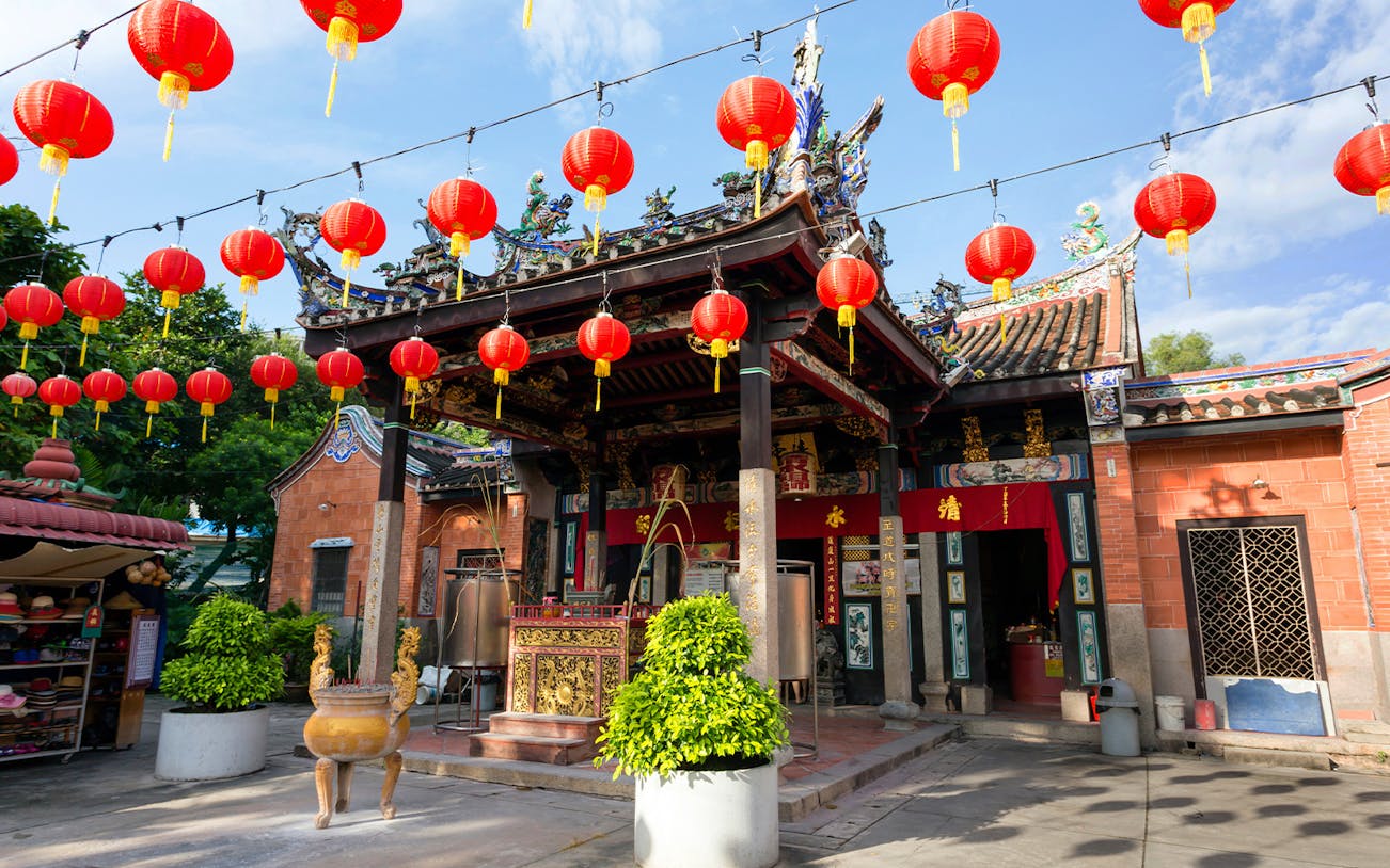 Chinese temple with red lanterns in Penang, Malaysia, part of the Round Island Full Day Tour.