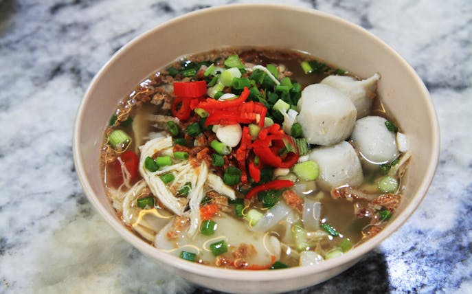 Bowl of Penang noodle soup with fish balls and vegetables on Georgetown food trail.