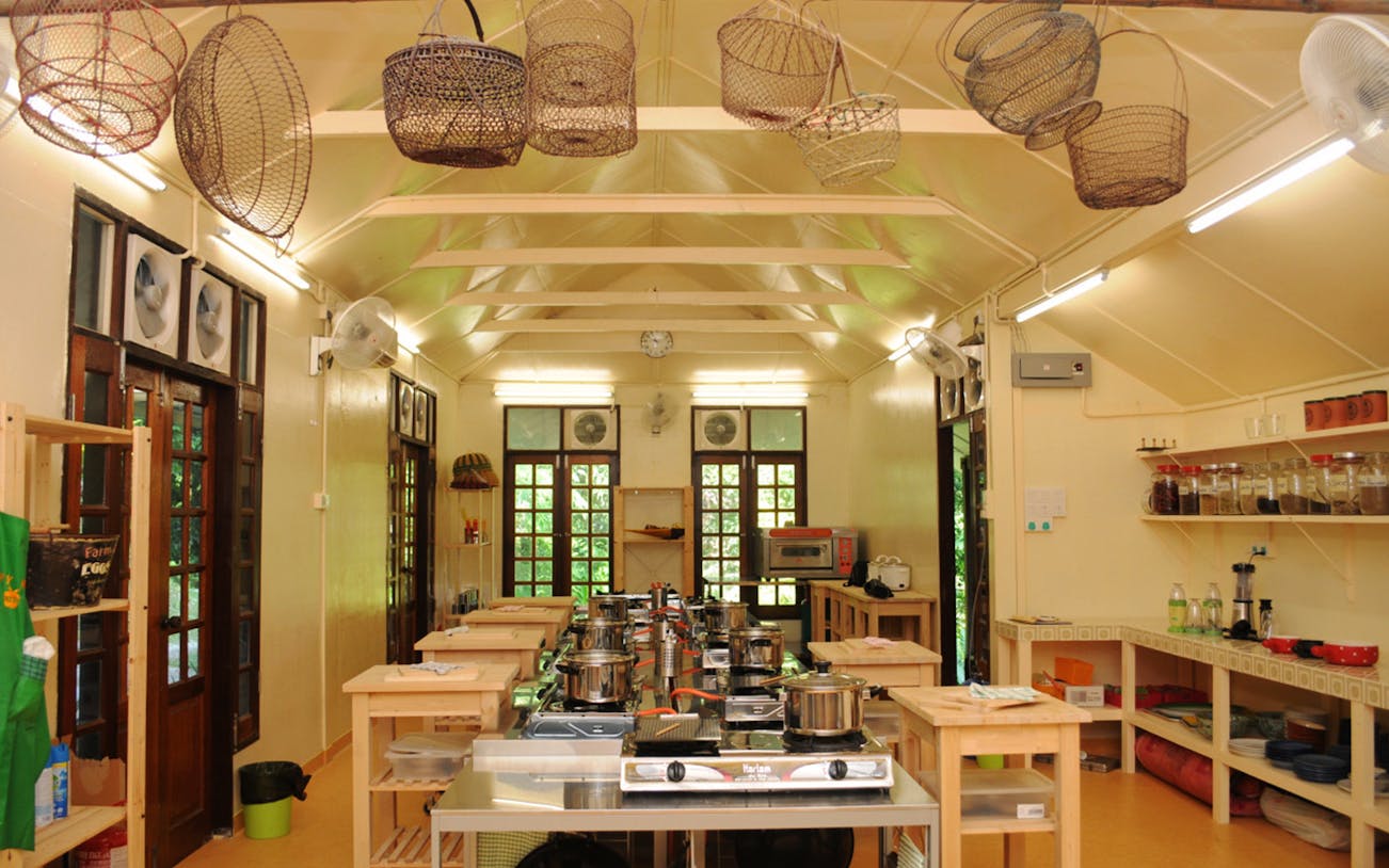 Cooking class setup with stoves and utensils in Penang local market kitchen.