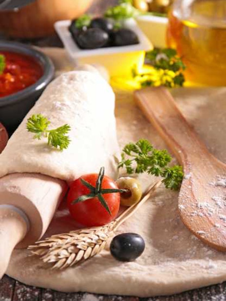 Pizza dough with fresh ingredients at Neapolitan cooking school in Sorrento.