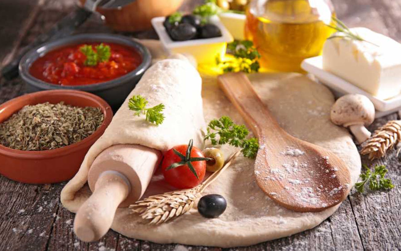 Pizza dough with fresh ingredients at Neapolitan cooking school in Sorrento.