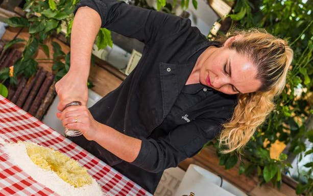 Woman preparing dough at Neapolitan cooking school in Sorrento.