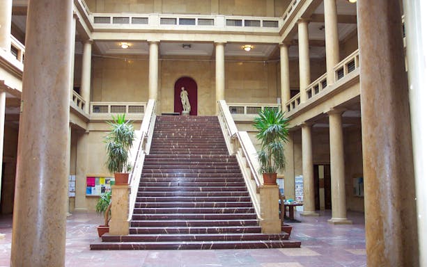 Grand staircase in Munich building associated with Third Reich history.
