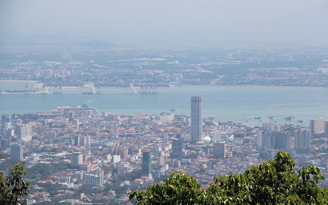 Aerial view of George Town from Penang Hill, featuring cityscape and coastline.