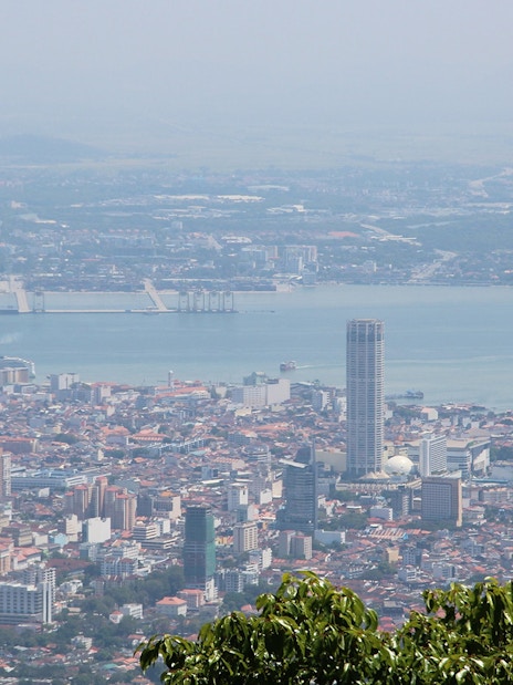 Aerial view of George Town from Penang Hill, featuring cityscape and coastline.