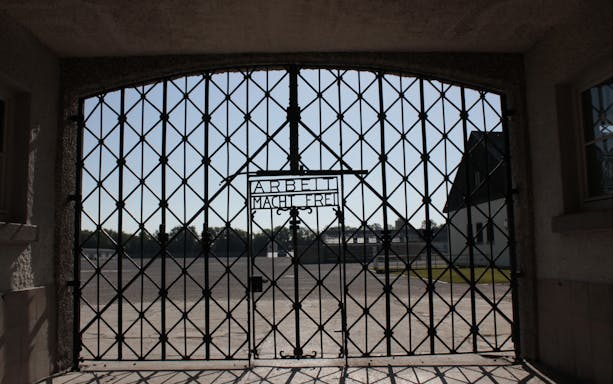 Visitors exploring Dachau Memorial, former concentration camp, Munich.