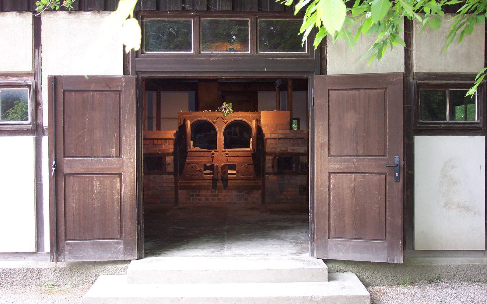 Open doors leading to the crematorium at Dachau Memorial, Germany.