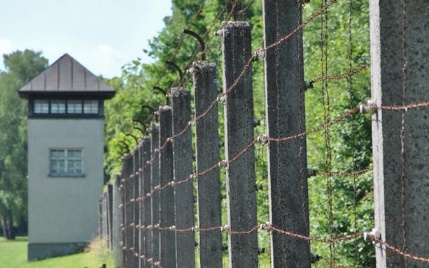 Visitors exploring Dachau Memorial, former concentration camp, Munich.