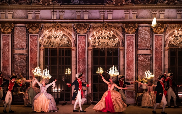 Performers in historical costumes dancing at Puy du Fou Theme Park.