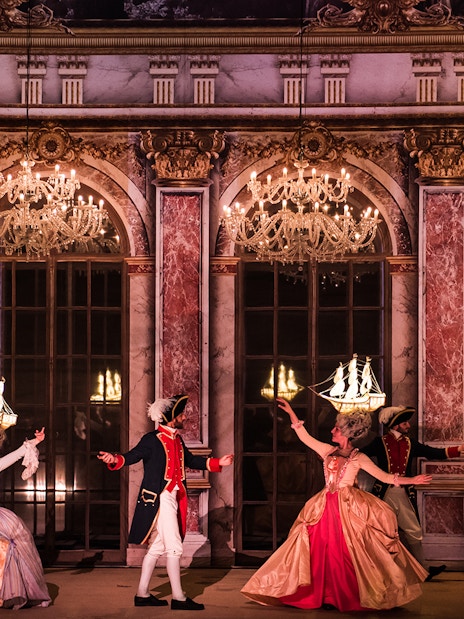 Performers in historical costumes dancing at Puy du Fou Theme Park.