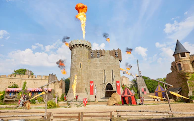 Medieval castle with fire effects at Puy du Fou Theme Park.