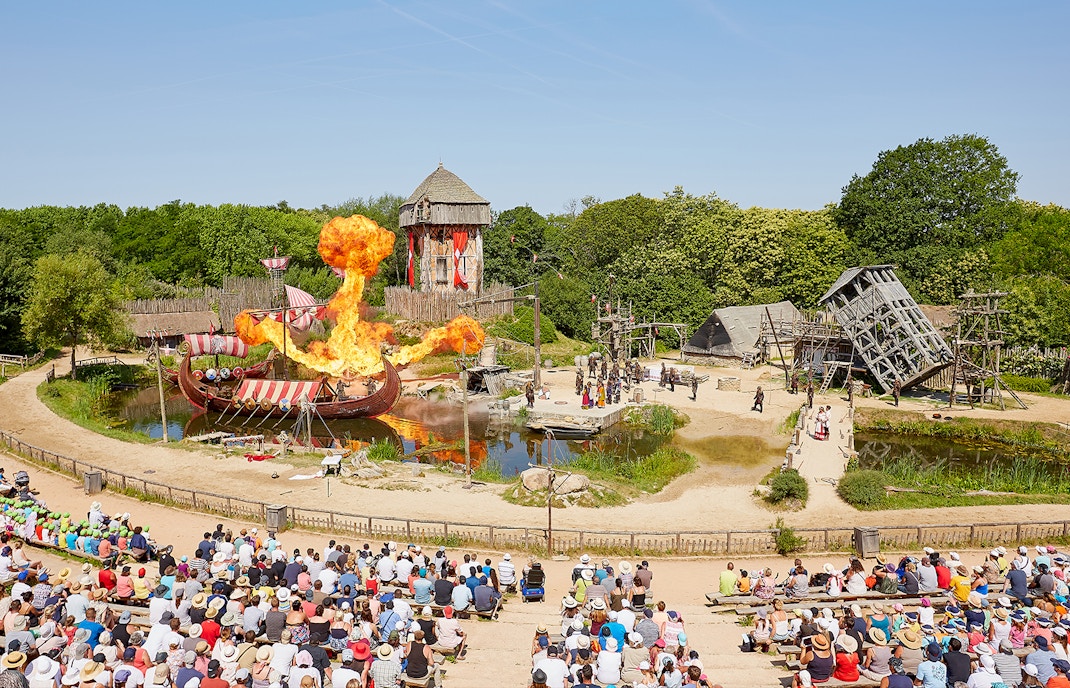 Puy du Fou Theme Park entrance with visitors entering through grand archway in Loire Valley, France.