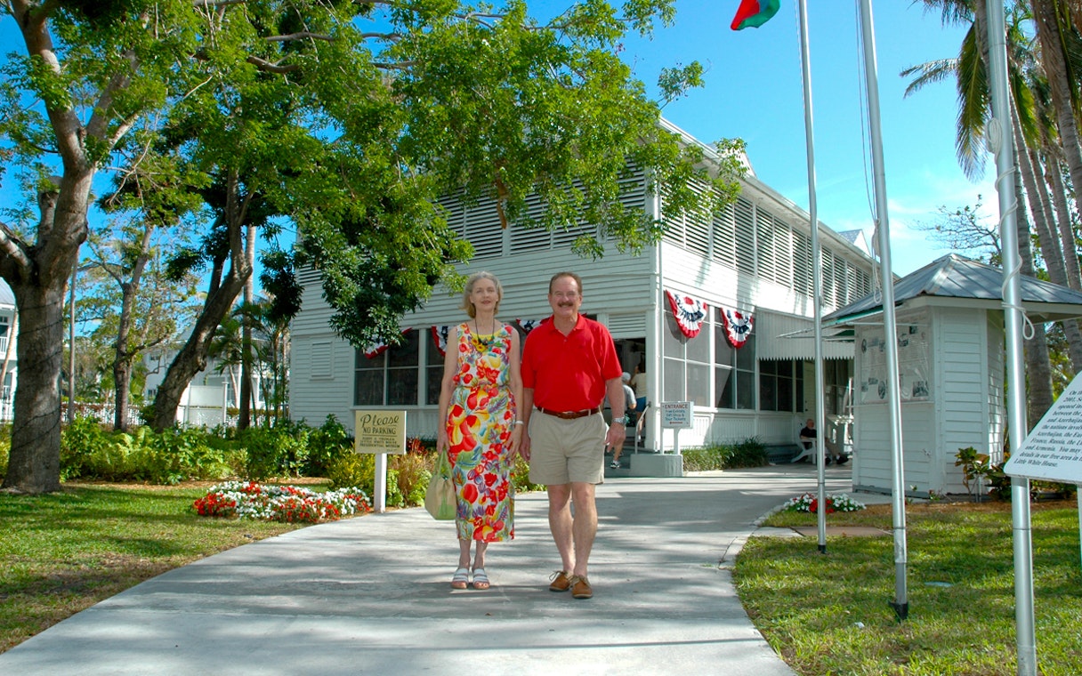 Couple walking outside Truman Little White House in Key West.