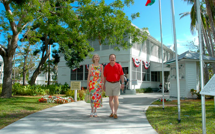 Couple walking outside Truman Little White House in Key West.