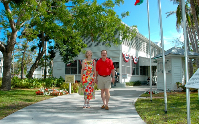 Couple walking outside Truman Little White House in Key West.