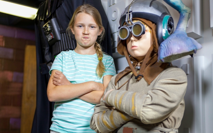 Child posing with a wax figure in St. Augustine Potter's Wax Museum.